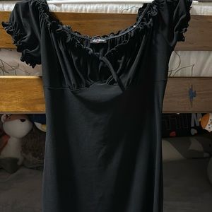 A stylish women's dress with cap sleeves, scoop neck, and a high, mini length.